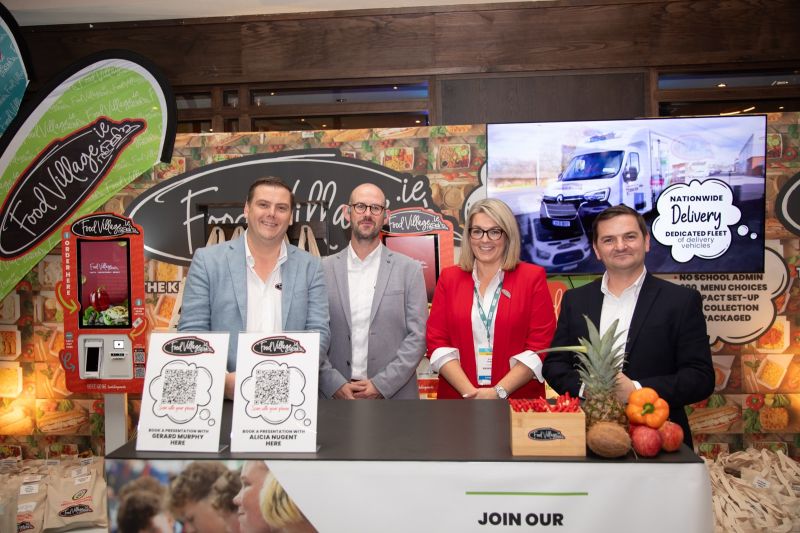 Food Village exhibition stand displaying school meal ordering technology, self-service kiosks and mobile app solutions.