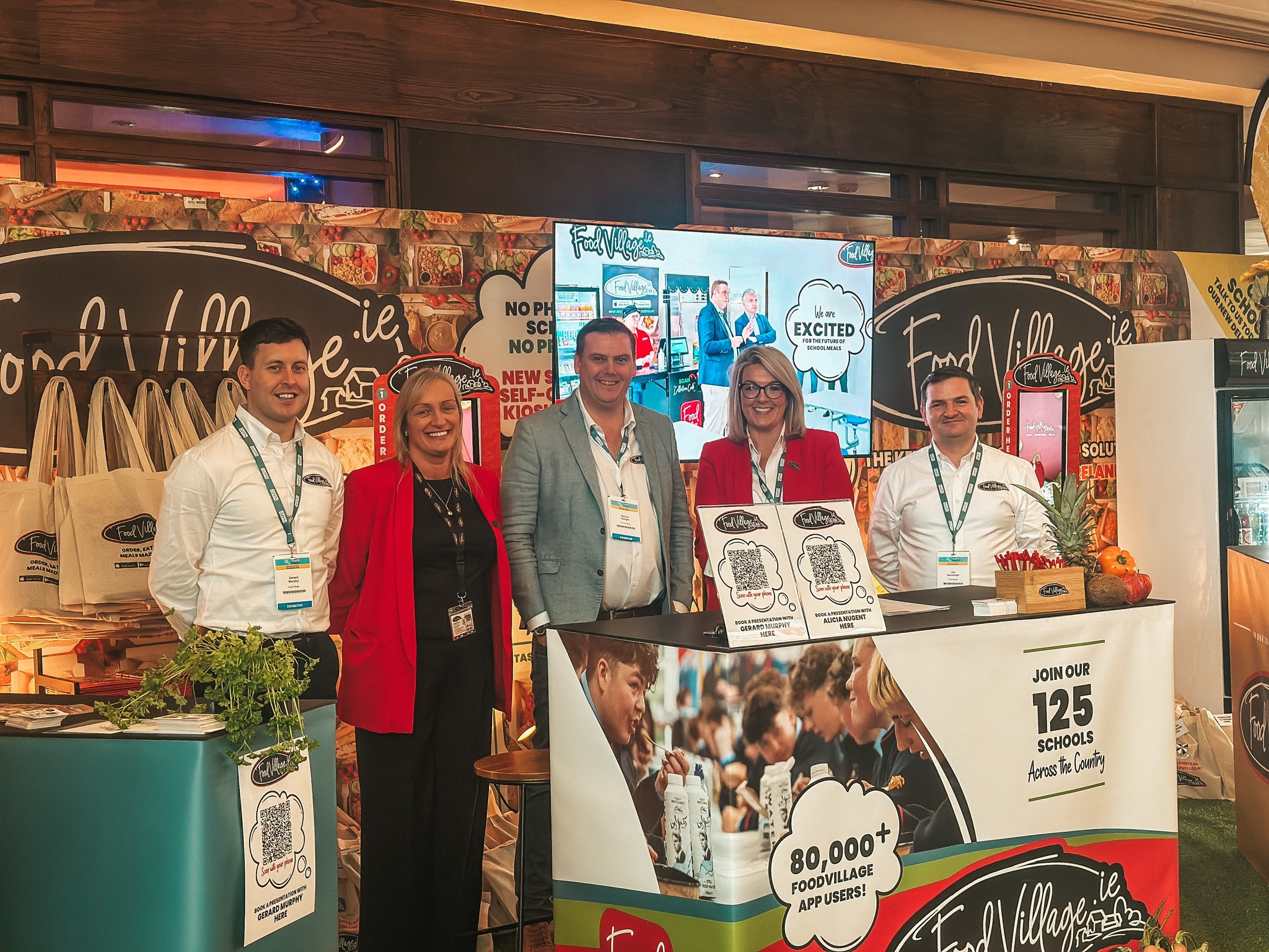 562285296_1641771070501392_3565207853340521883_n Food Village team showcasing school meal and app solutions at an education and food industry exhibition.