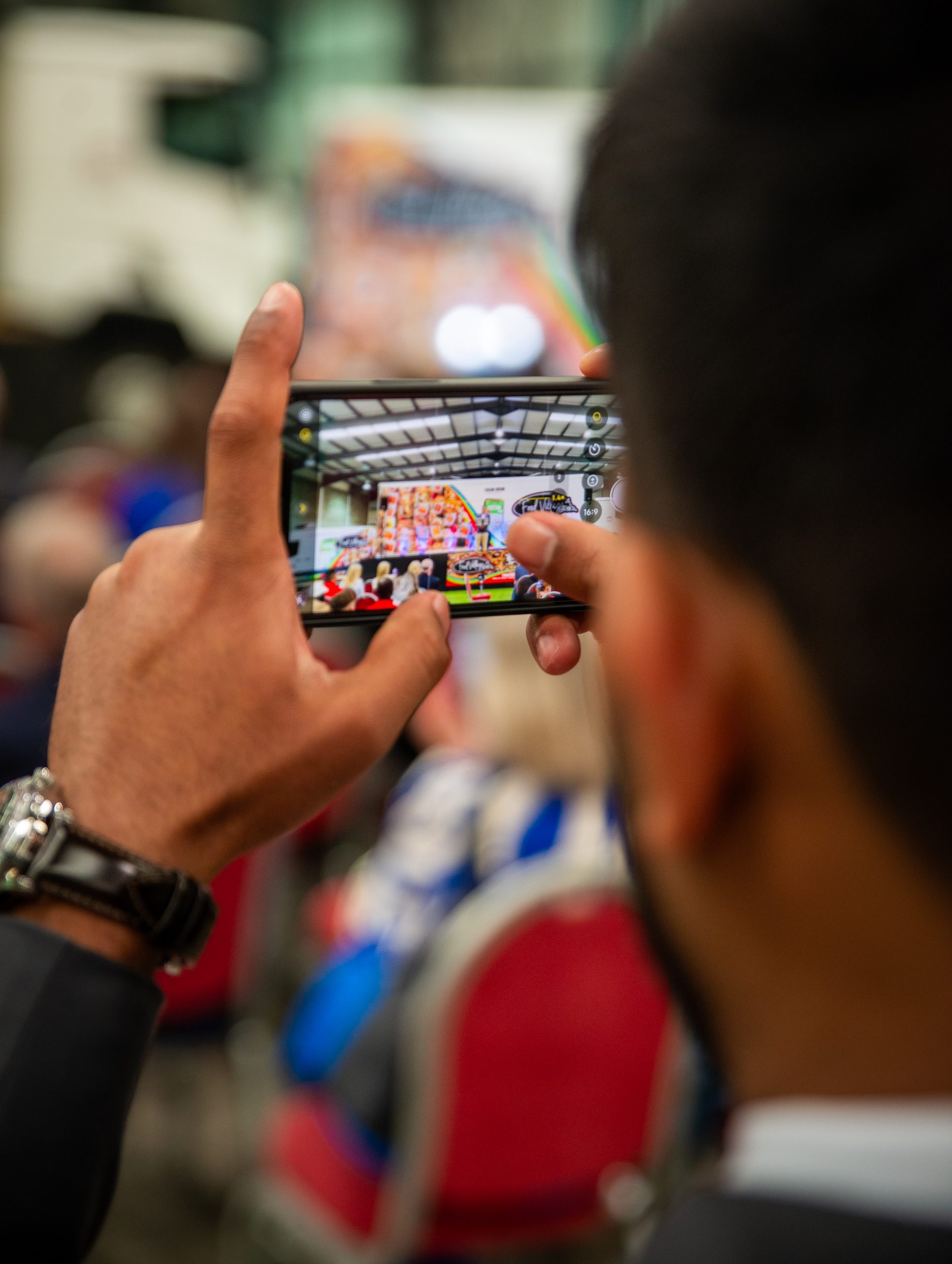 DSC_3563 Attendee taking a photo at a Food Village event showcasing school meals, technology and community engagement.