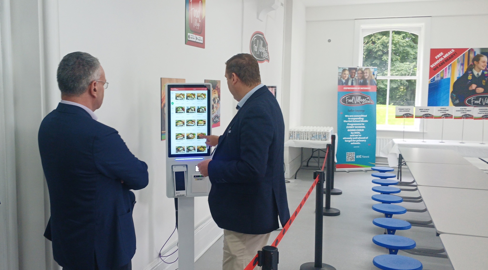 St.Muredeachs_FV New Canteen 2 Food Village digital food ordering kiosk being demonstrated inside a school dining area.
